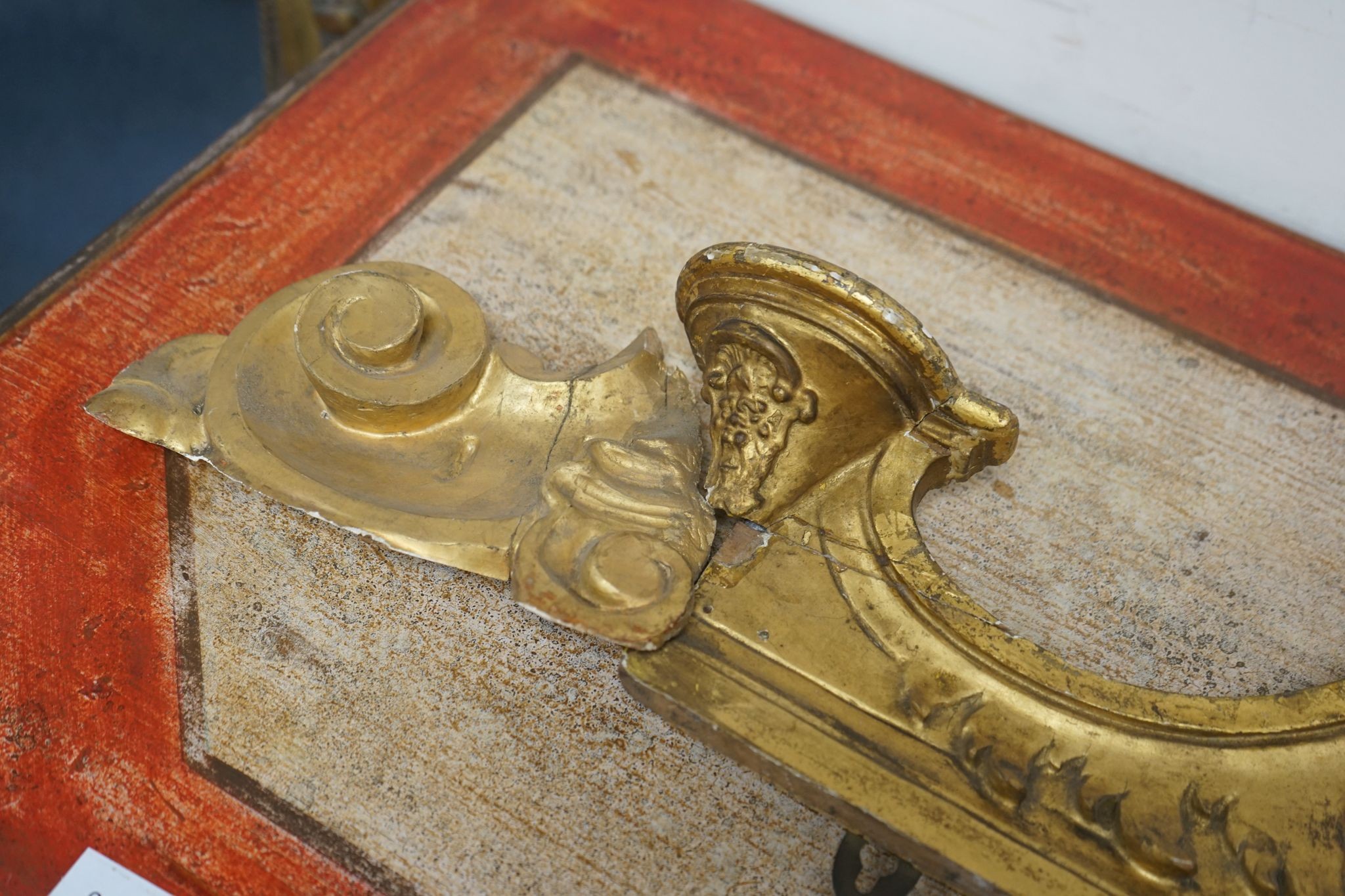 A 19th century carved giltwood pediment, width 142cm